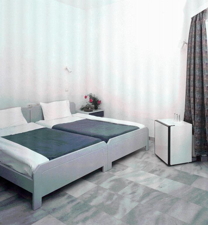 Postel nebo postele na pokoji v ubytování Akasti Hotel