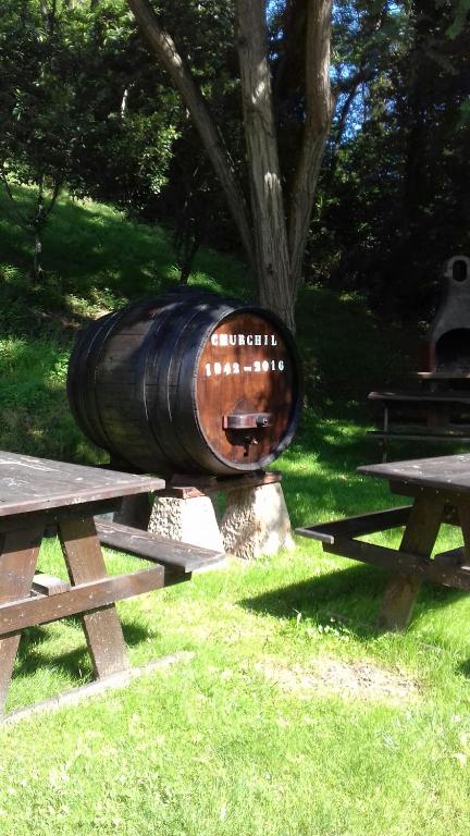 a barrel sitting on top of two picnic tables at Apartamentos Rurales Les Mestes in Tazones