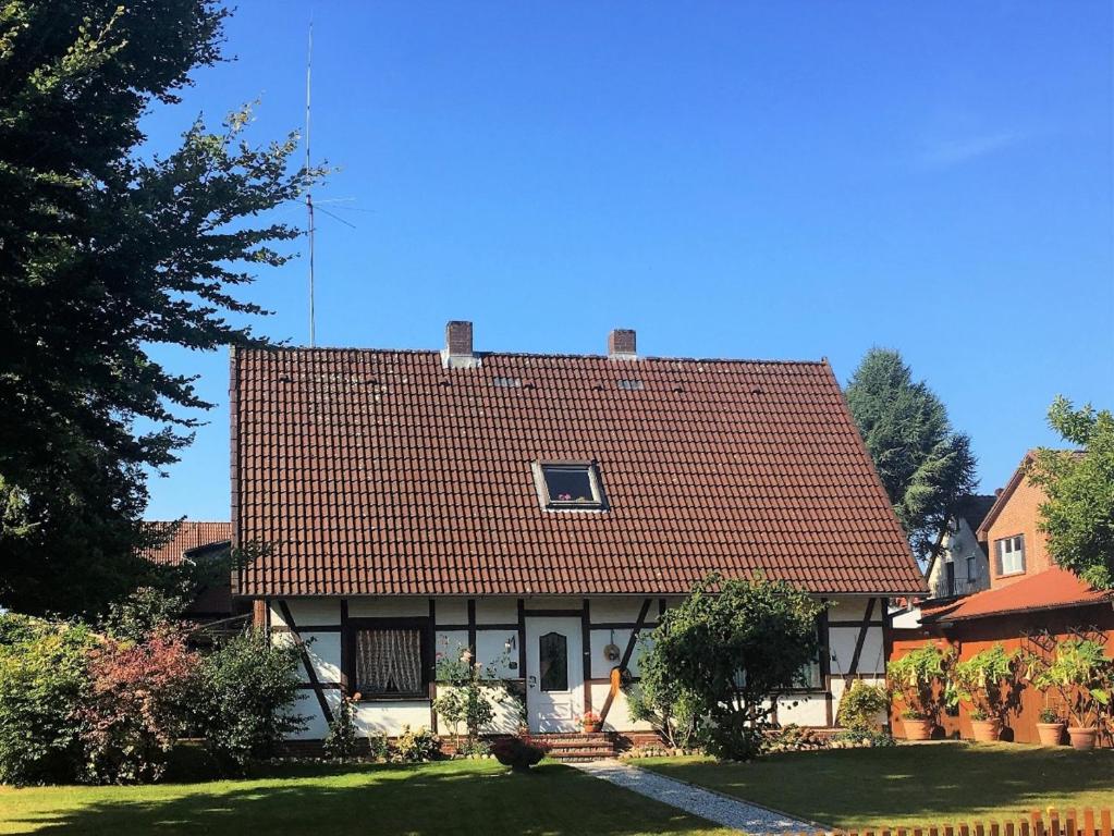 una casa con techo rojo en un patio en Am-Immenweg, en Bad Fallingbostel