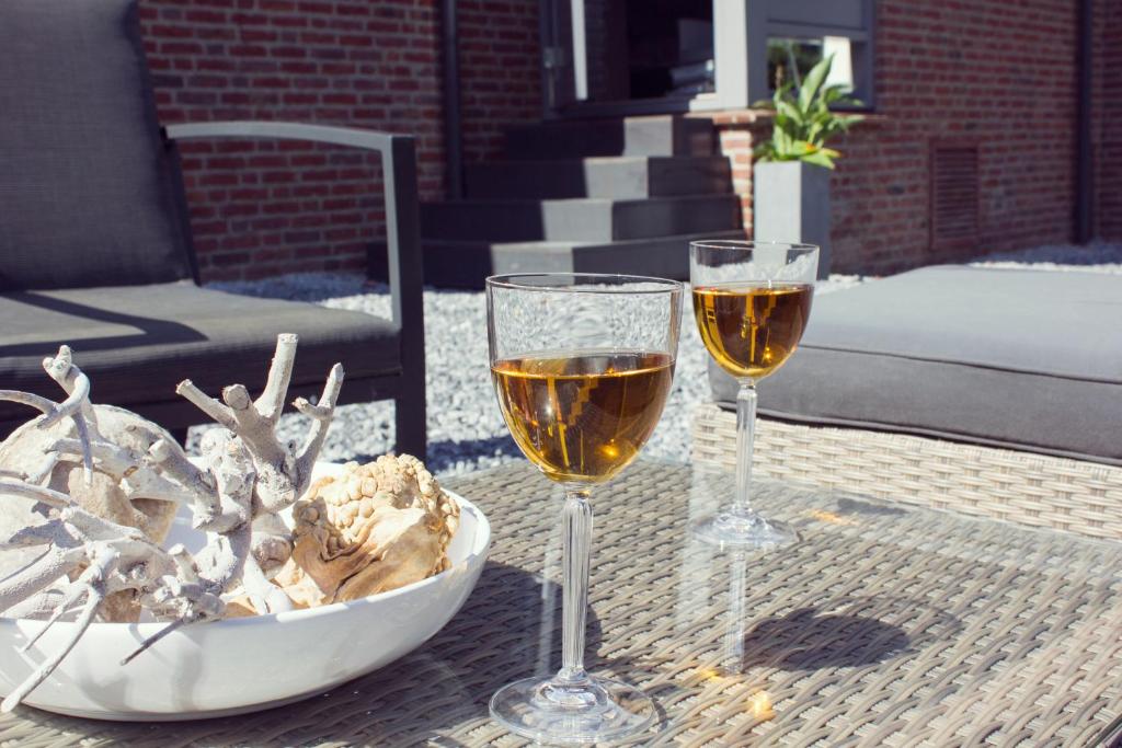 B&B Landgoed Bergerven في هورن: كأسين من النبيذ يجلسون على طاولة
