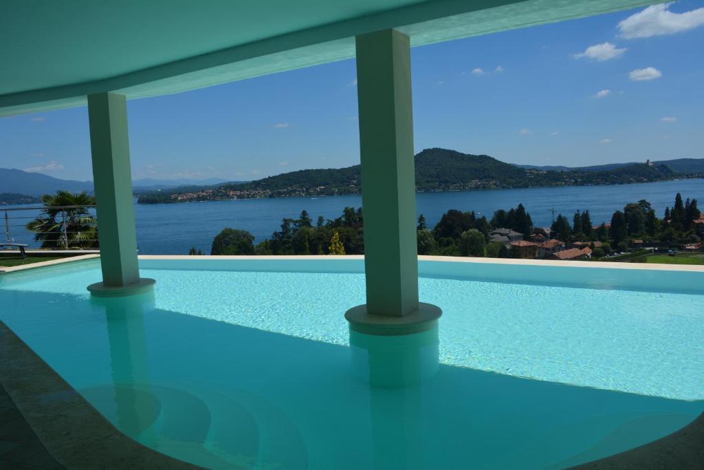 a swimming pool with a view of the water at Il Girasole in Meina