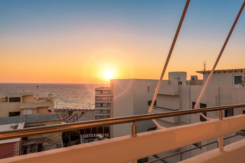 a view of the sunset from a cruise ship at Sea and the city in Rhodes Town