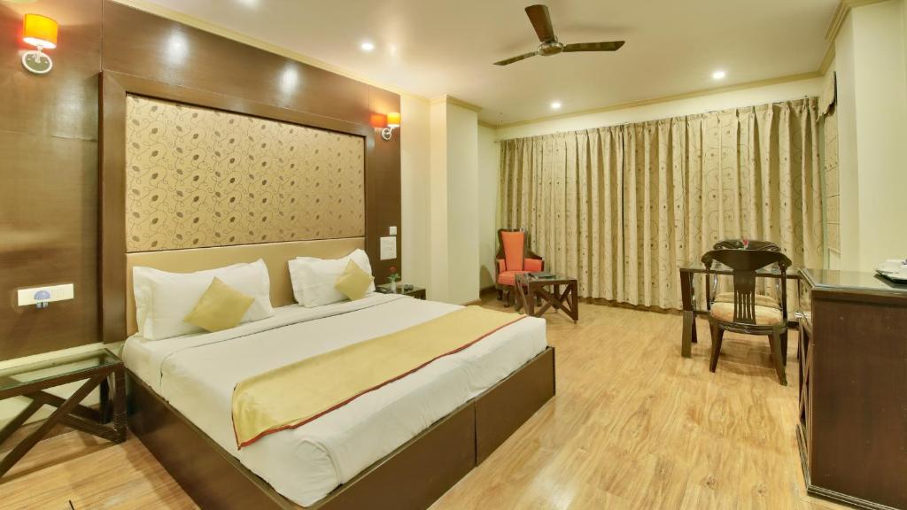 a hotel room with a bed and a desk and a chair at Milestone 251 in Jaipur