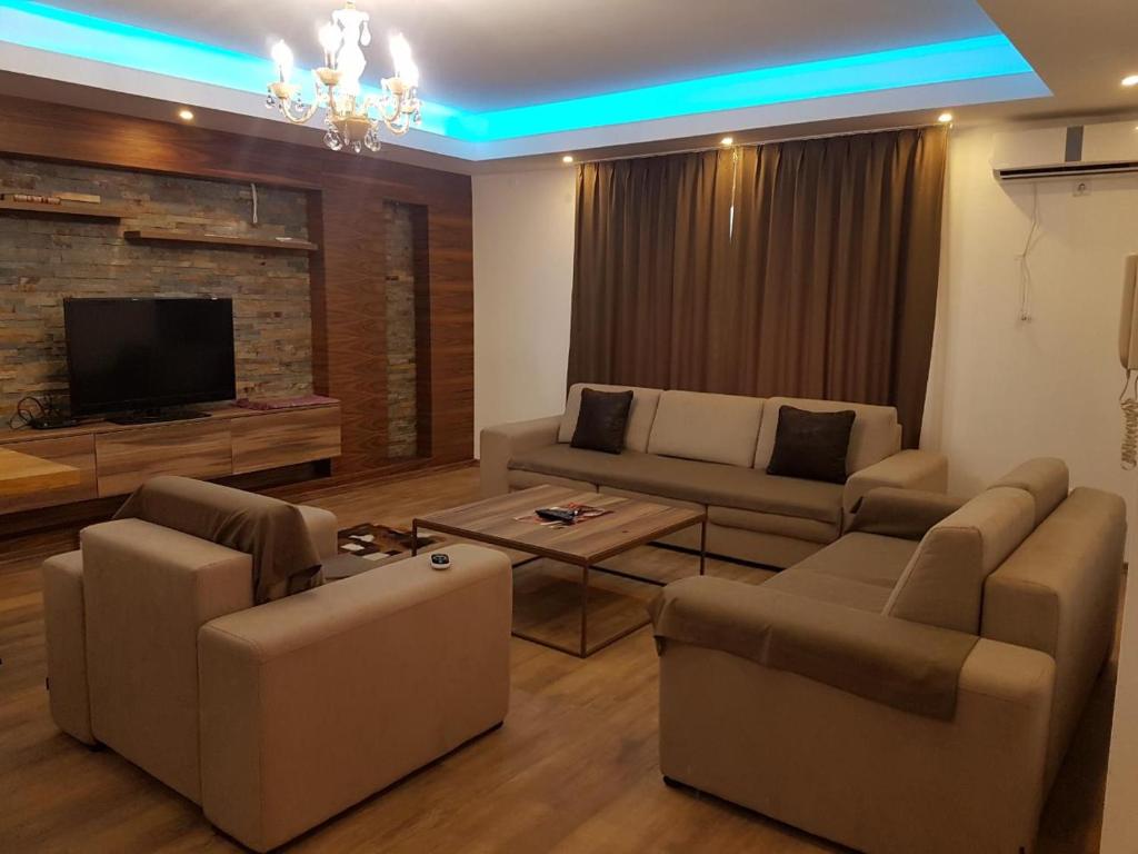 a living room with a couch and a tv at Sarajevo city rent in Sarajevo