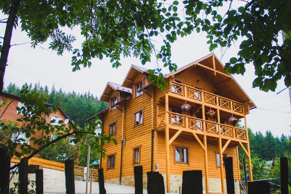 a large wooden building with a balcony at Guest House Svitliza in Yaremche