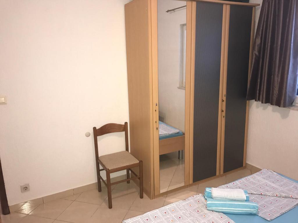 Postel nebo postele na pokoji v ubytování Apartmani Dora