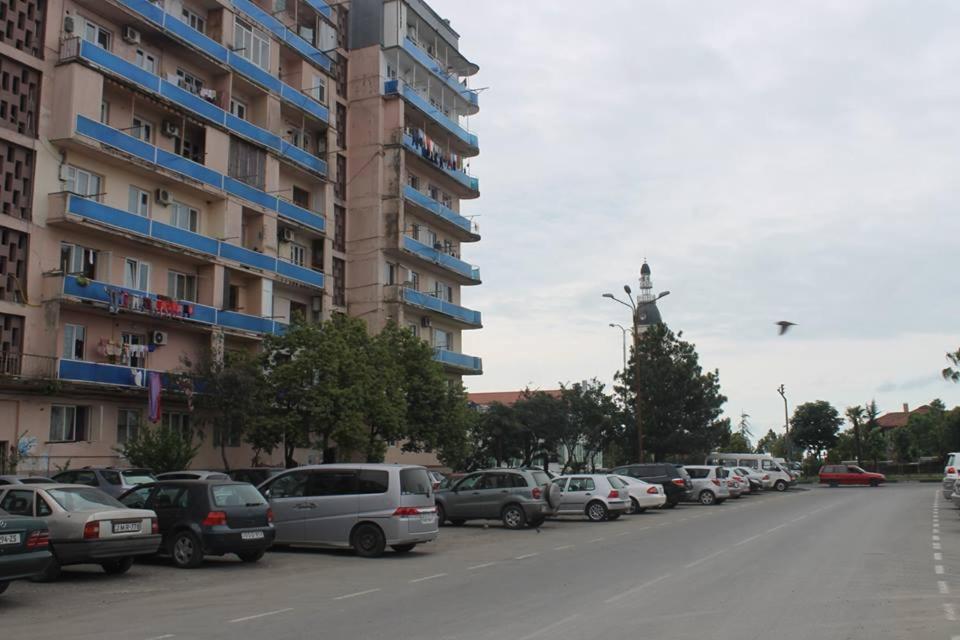 a row of cars parked in a parking lot next to a building at Apartment Khimshiashvili 9 in Batumi