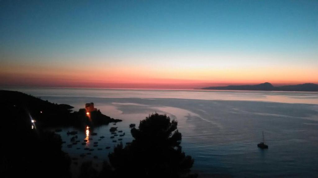 a sunset over a large body of water at Villa Crawford in San Nicola Arcella