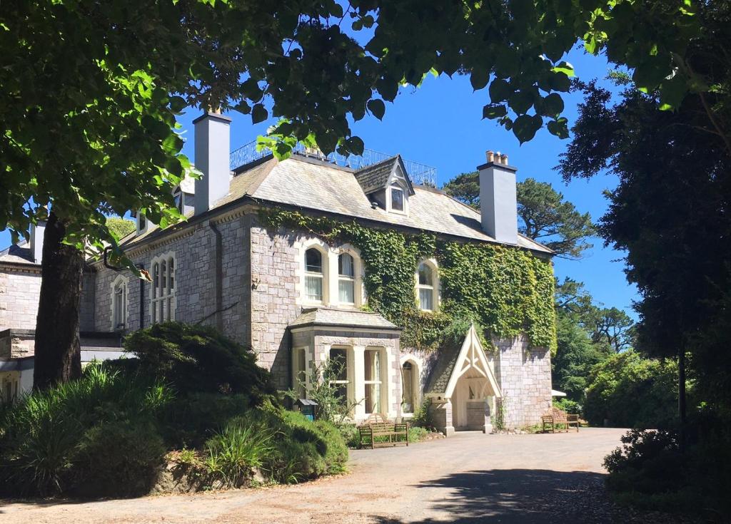 an old stone house with ivy on it at Penmorvah Manor Hotel in Falmouth