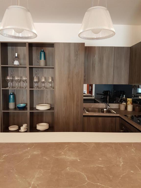 a kitchen with wooden cabinets and two lights at Villa Crawford in San Nicola Arcella