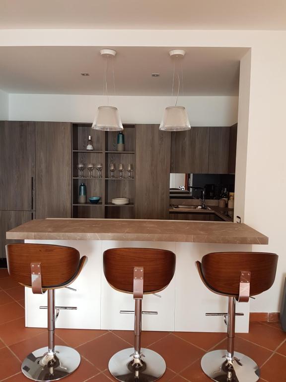 a kitchen with a counter and two bar stools at Villa Crawford in San Nicola Arcella
