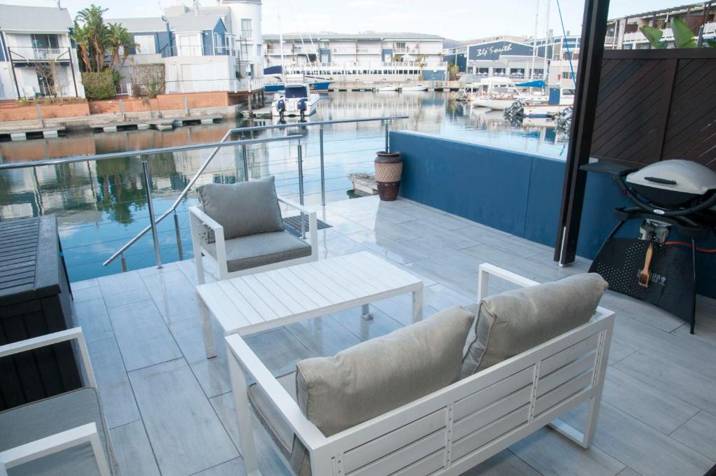a balcony with a couch and a table on a building at 3 Spinnaker The Quays in Knysna