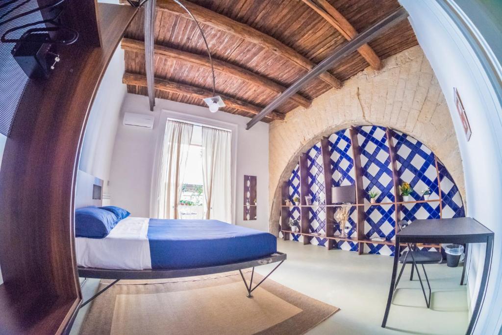 a bedroom with a bed and a large window at Per Amor Duomo in Naples