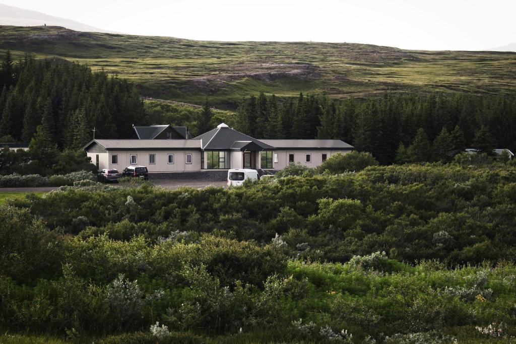 a house in the middle of a field at Guesthouse Svartiskógur Egilsstaðir in Svartiskogur