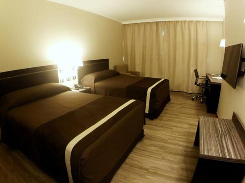 Postel nebo postele na pokoji v ubytování Hotel Diego de Almagro Providencia