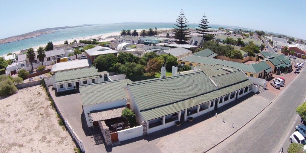 arial view of a town with a building and a beach at Langebaan Kite Cottages in Langebaan