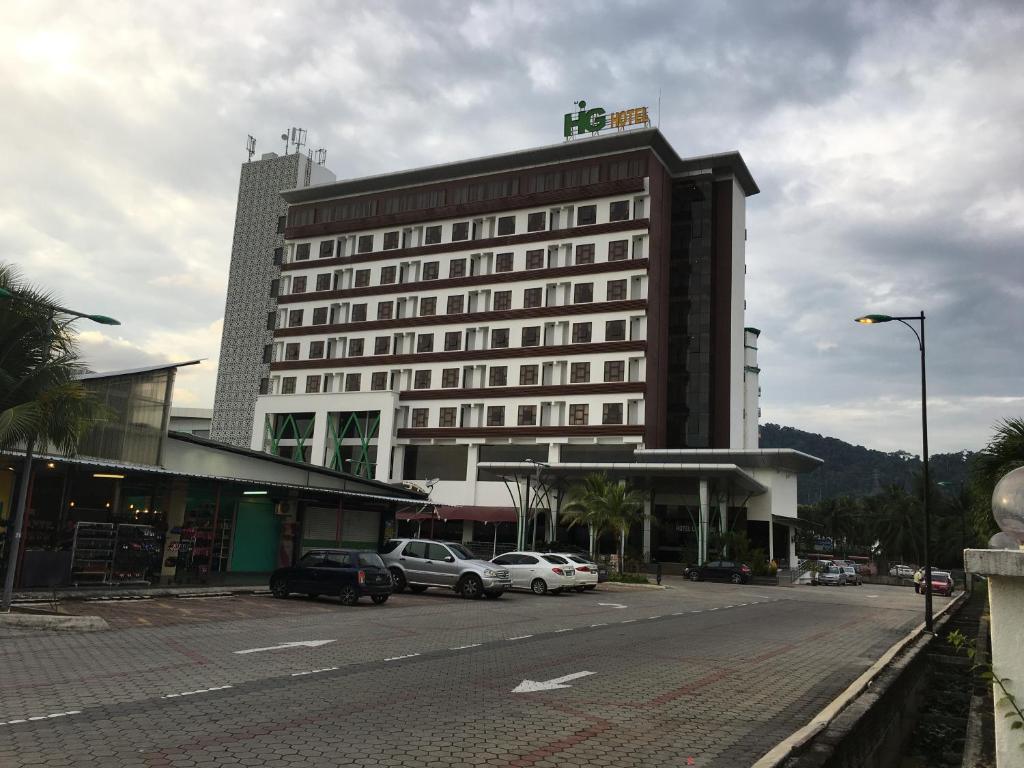 瓜埠的住宿－HIG酒店，停车场内停放汽车的大型建筑