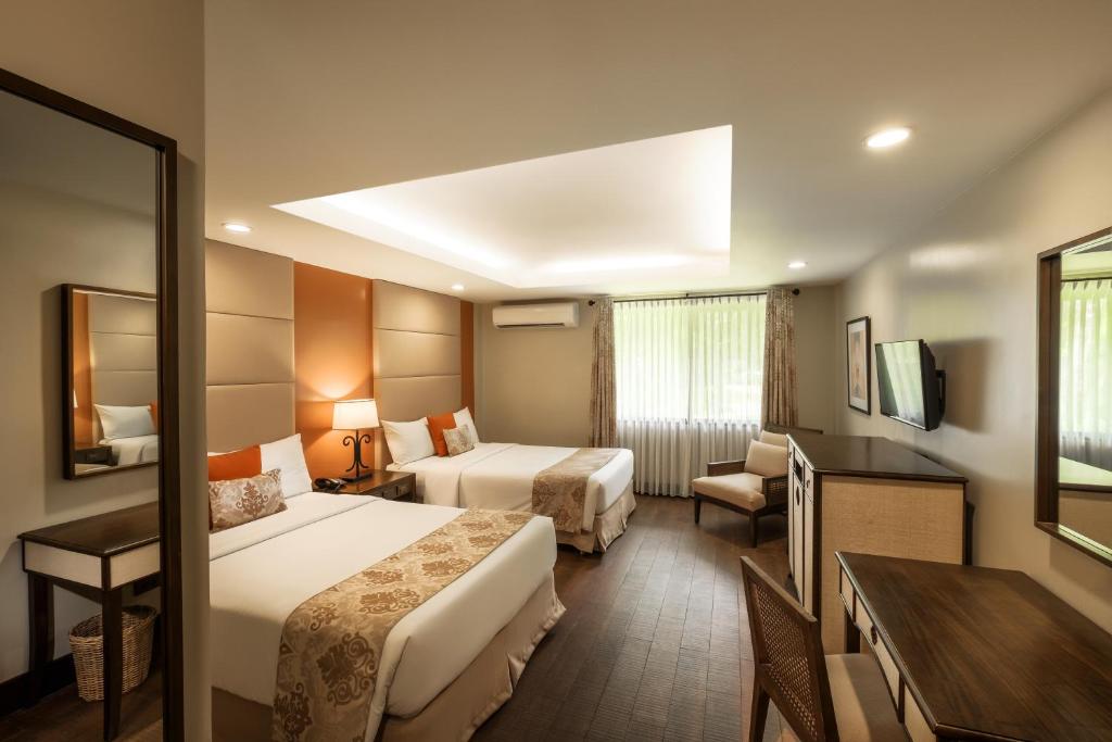 Postel nebo postele na pokoji v ubytování Montebello Villa Hotel