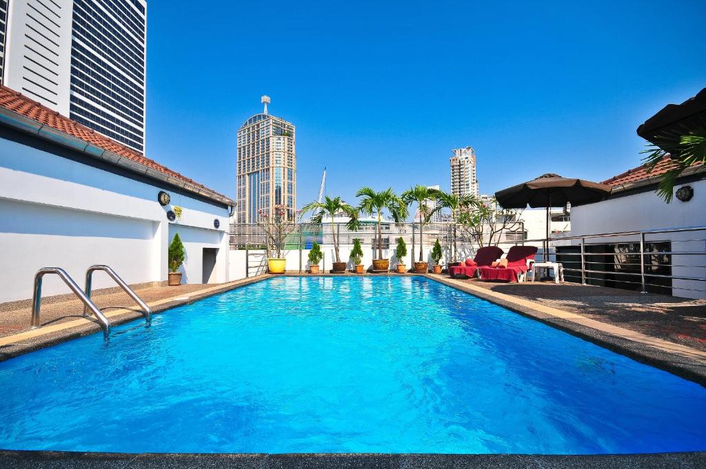 a swimming pool with a view of the city at Admiral Suites Bangkok in Bangkok