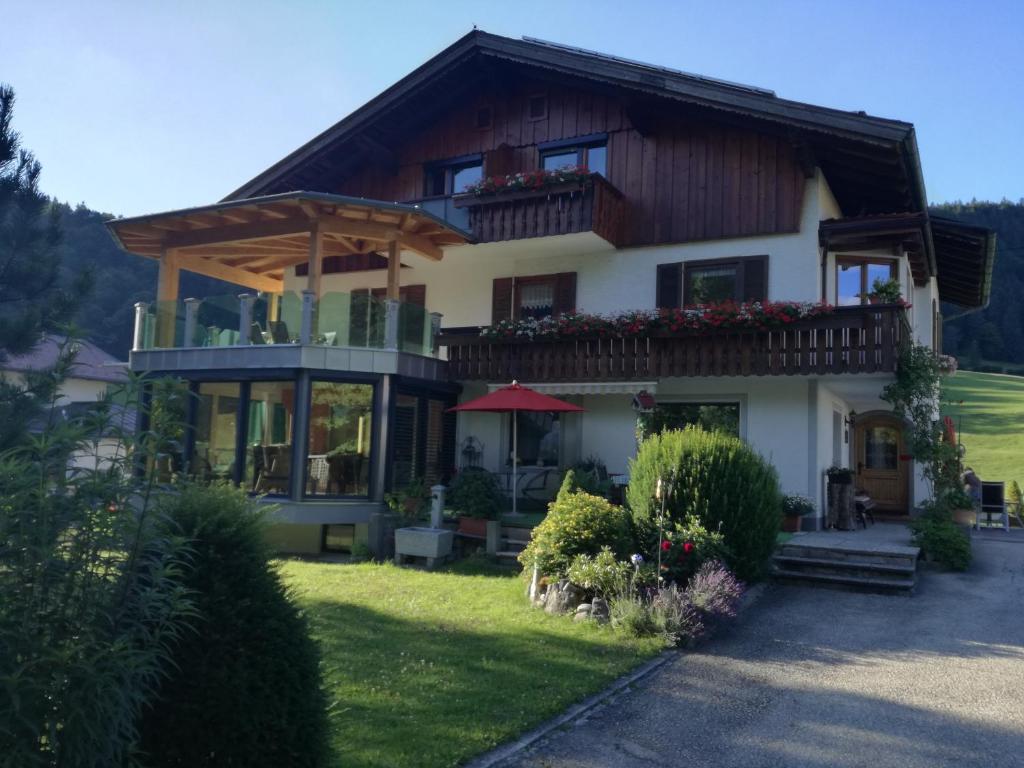 a large house with a balcony on top of it at Landhaus Fuchs in Walchsee