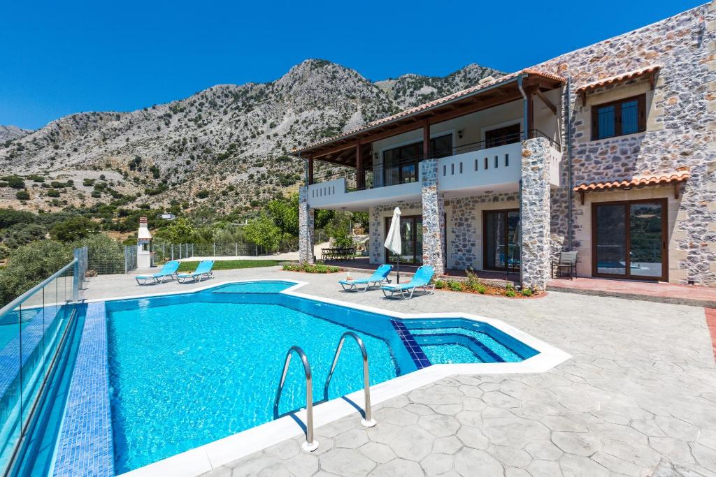 a villa with a swimming pool and a house at Villa Asigonia in Asigonía