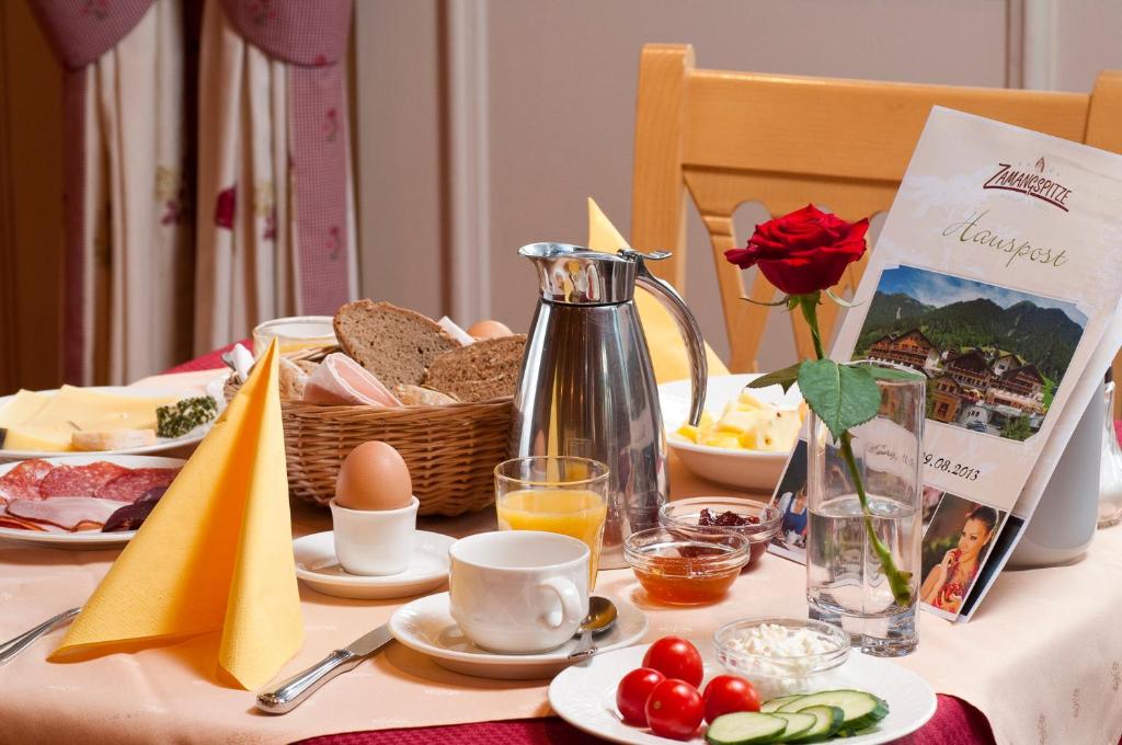 a table with a breakfast of eggs and bread at Berg-Spa & Hotel Zamangspitze in Sankt Gallenkirch