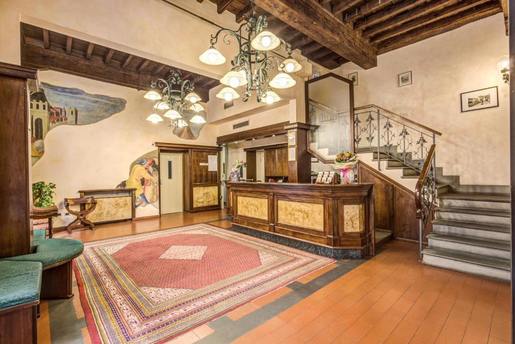 a large room with a staircase and a rug at Hotel De Lanzi in Florence