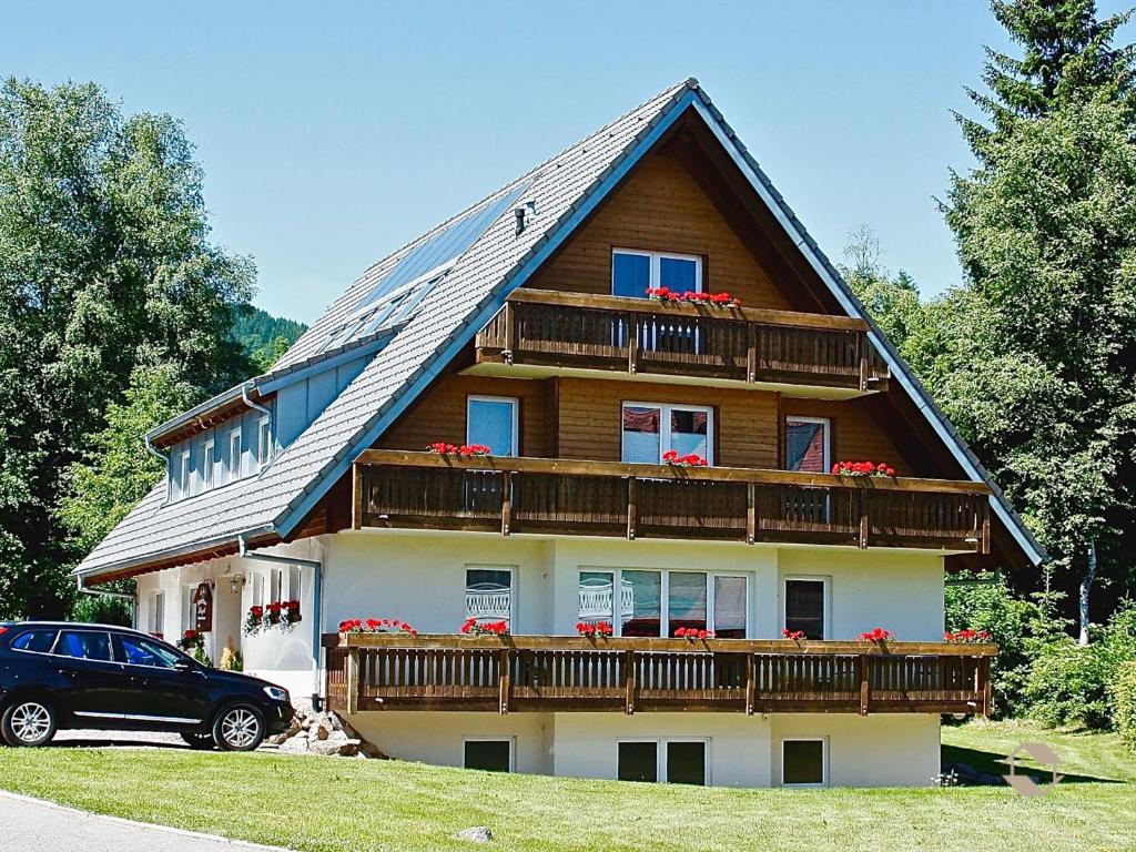 a house with a car parked in front of it at Gästehaus Klingele in Hinterzarten