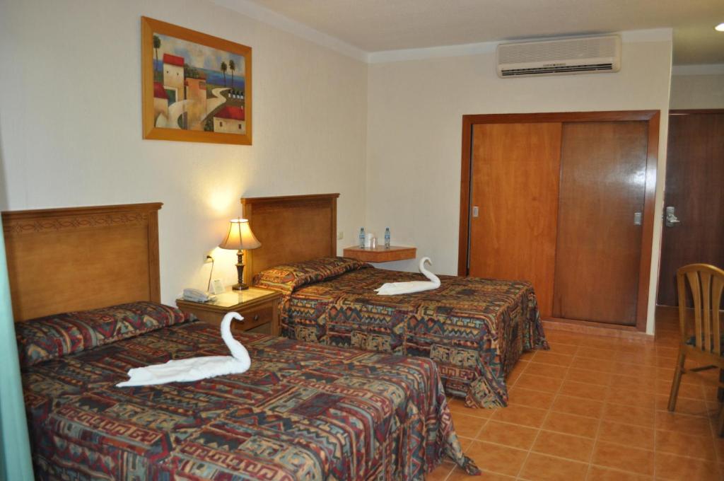 Postel nebo postele na pokoji v ubytování Tecnohotel Mérida Norte