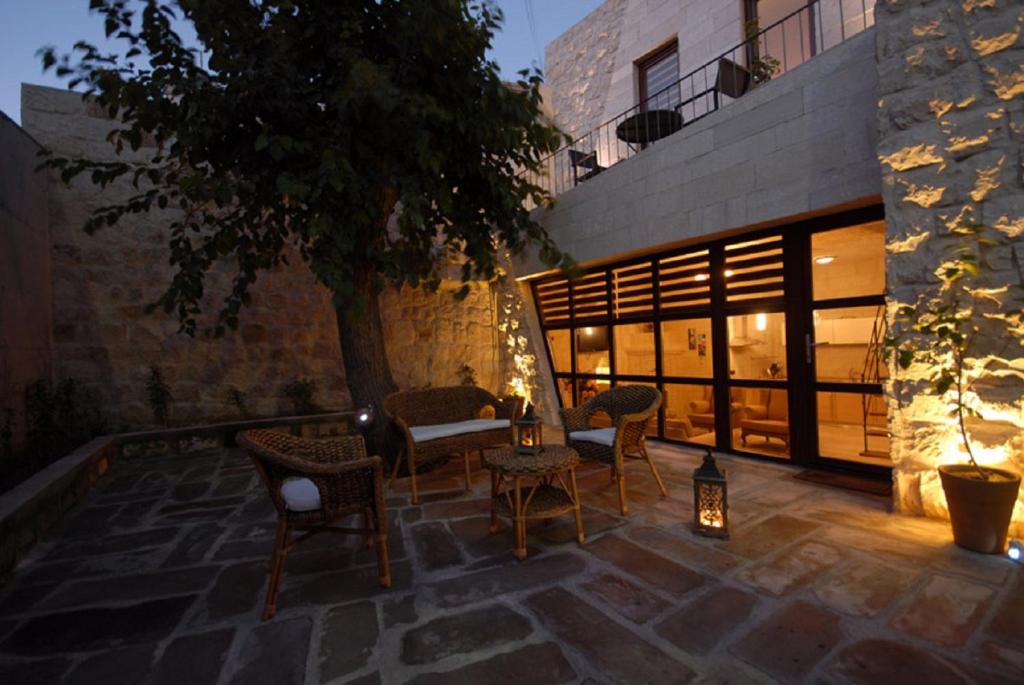 a patio with chairs and a table with lights at King Apart By Traveller's in Goreme