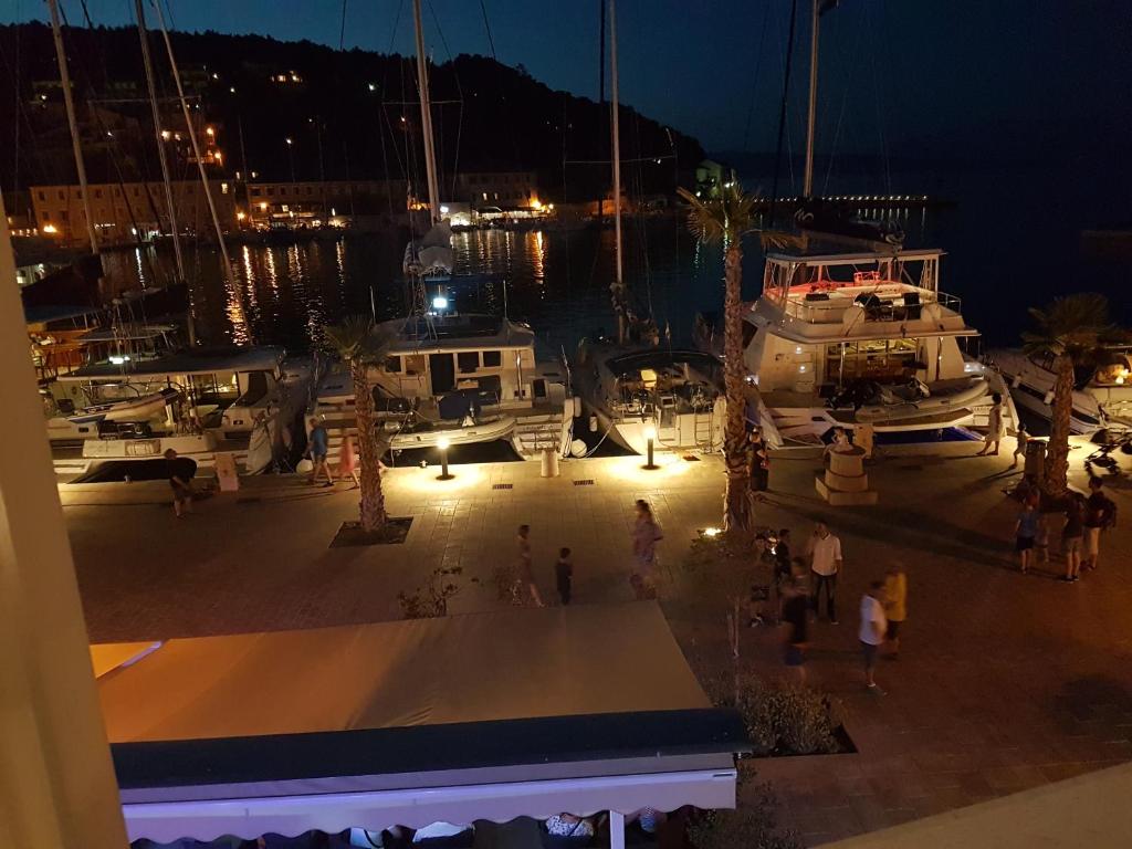 a group of people walking around a marina at night at Villa Riva in Jelsa