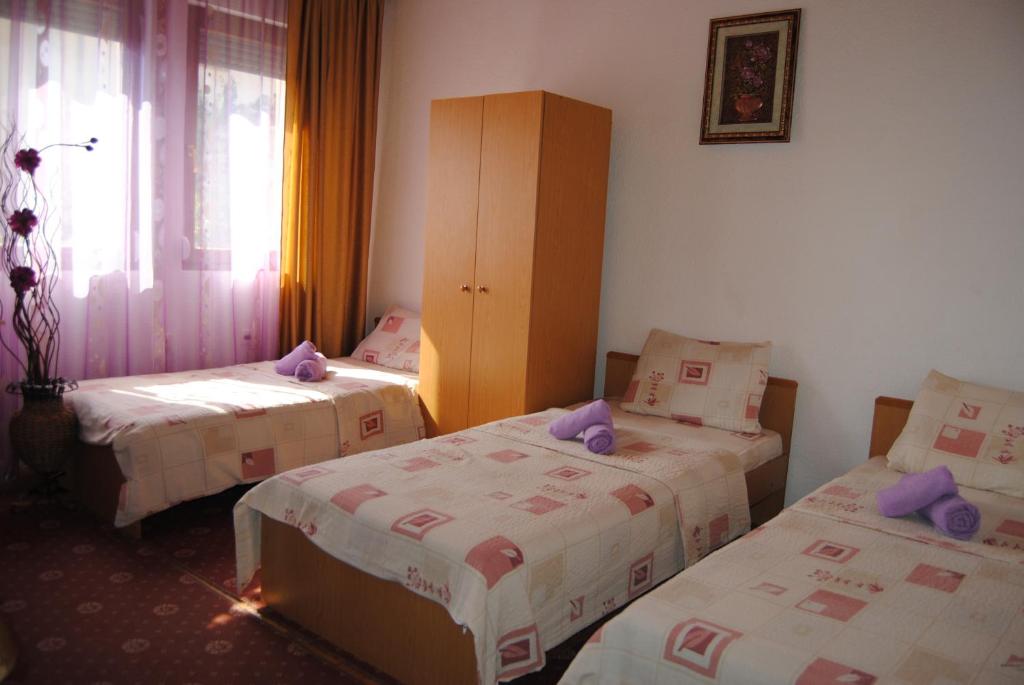 a room with two beds and a cabinet in it at Joleski Accommodation in Ohrid
