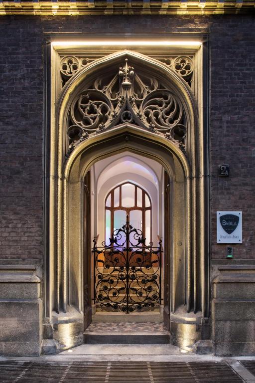 un ingresso a un edificio con cancello di metallo di Babila Hostel & Bistrot a Milano