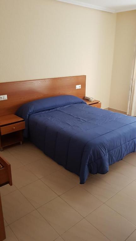 A bed or beds in a room at Hostal Orly