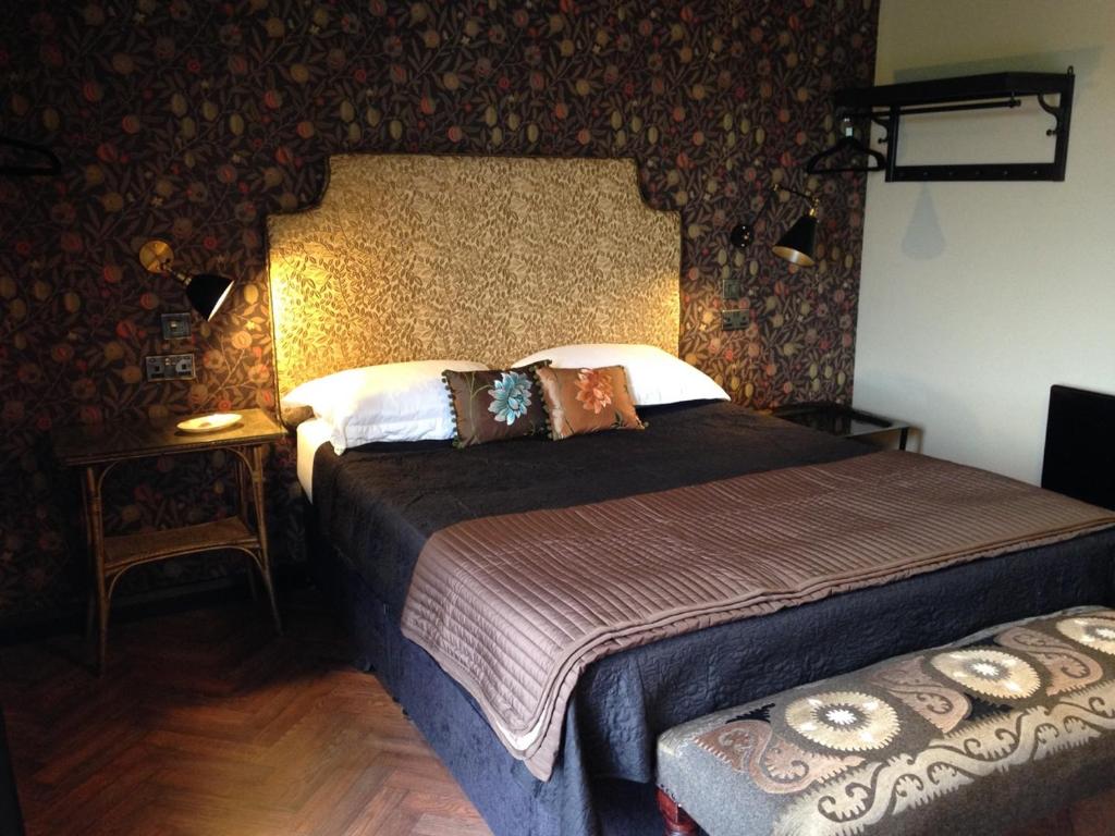 a bedroom with two beds in a room with wallpaper at Gower View Luxury Bed & Breakfast in Tenby