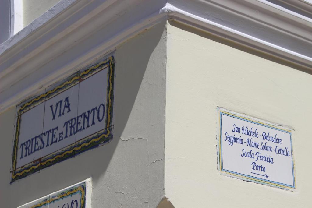 a sign on the side of a building with signs on it at Villa Pollio Guest House in Anacapri