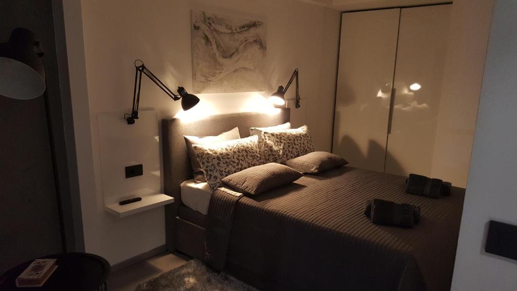 a bedroom with a bed with two pillows on it at Apartman VIP, with Free Garage Parking in Pula