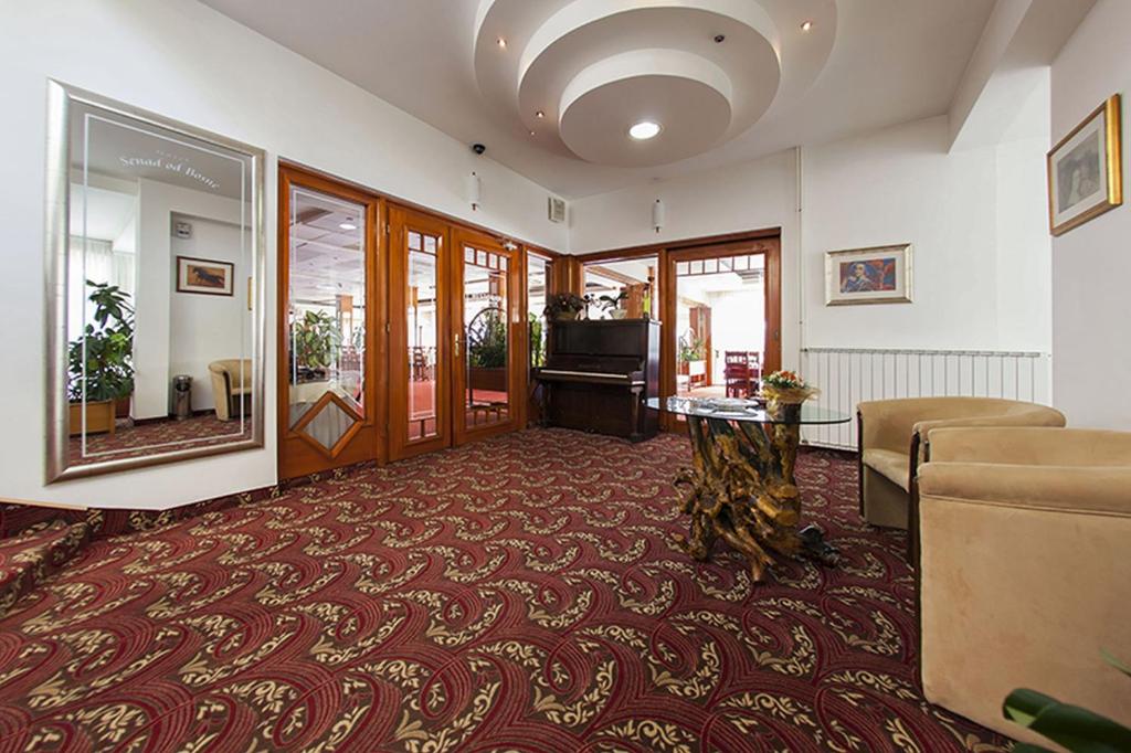 a living room with a couch and a table at Hotel Senad od Bosne in Prokosovići