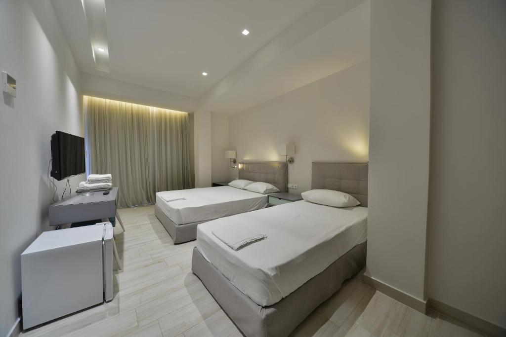 Postel nebo postele na pokoji v ubytování Hotel Kakanakos