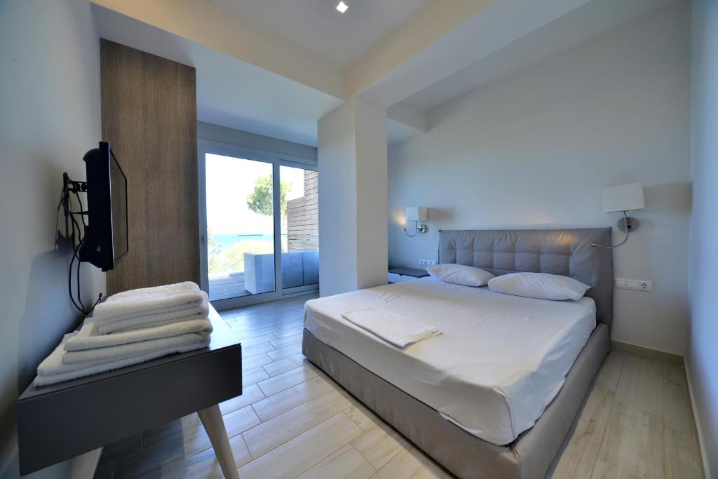 a bedroom with a bed and a television in it at Hotel Kakanakos in Loutra Oraias Elenis