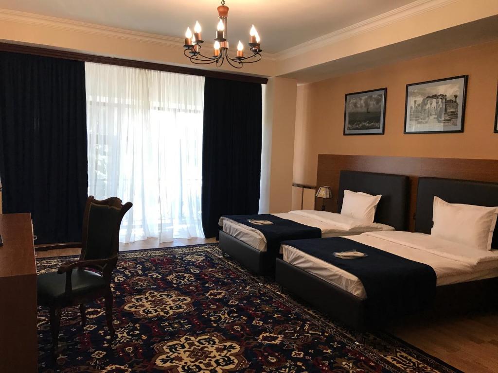 Postel nebo postele na pokoji v ubytování Hotel Plaza Viktoria