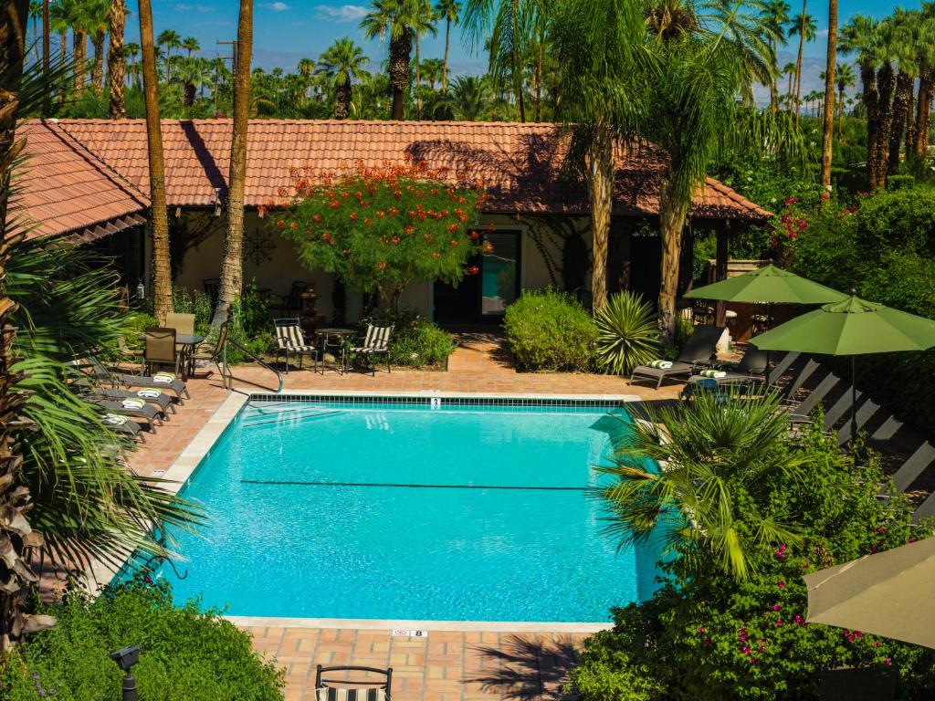 a swimming pool in front of a house at La Maison Hotel - Adults Only in Palm Springs