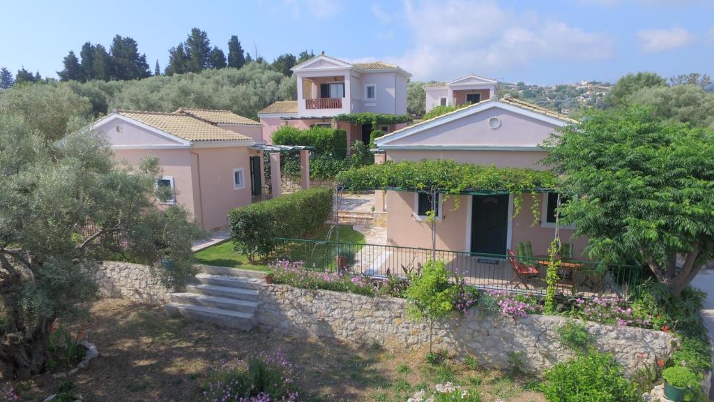 a house on a hill with a stone wall at Harmony Villas in Lygia