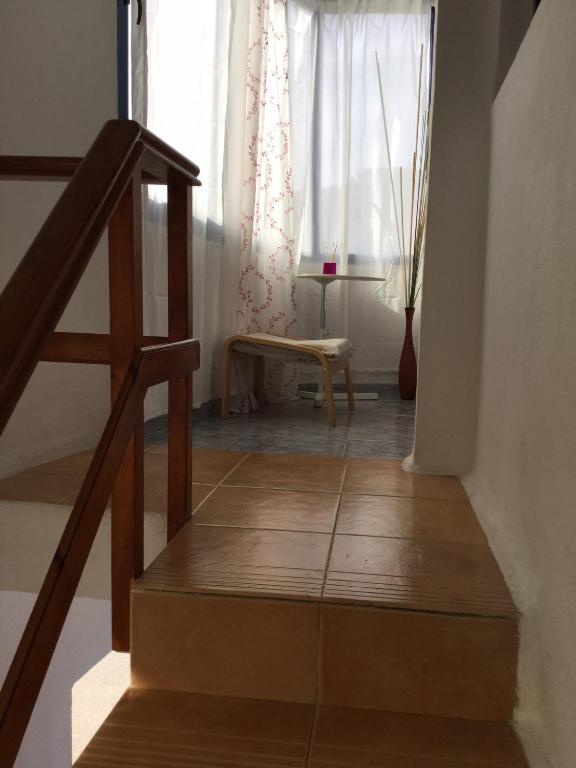 a stairway with a bench and a window at Tranquilo y Acogedor Apartamento in Órzola