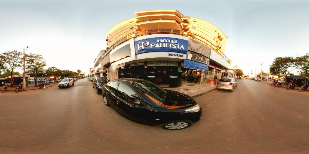 a black car parked in front of a building at Hotel Paulista in Unaí