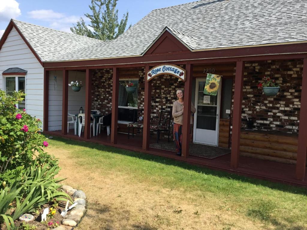 a woman standing in the doorway of a building at Rose Cottage Bed & Breakfast in Valemount