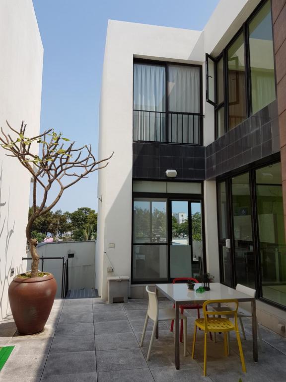a patio of a house with a table and chairs at Tainan Anping - Shuiau 180 in Anping