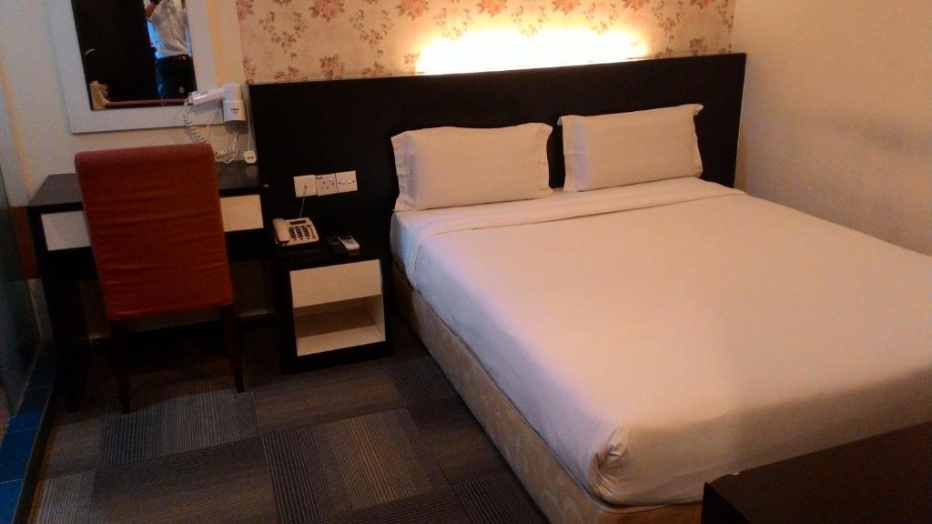Postel nebo postele na pokoji v ubytování Prince Hotel