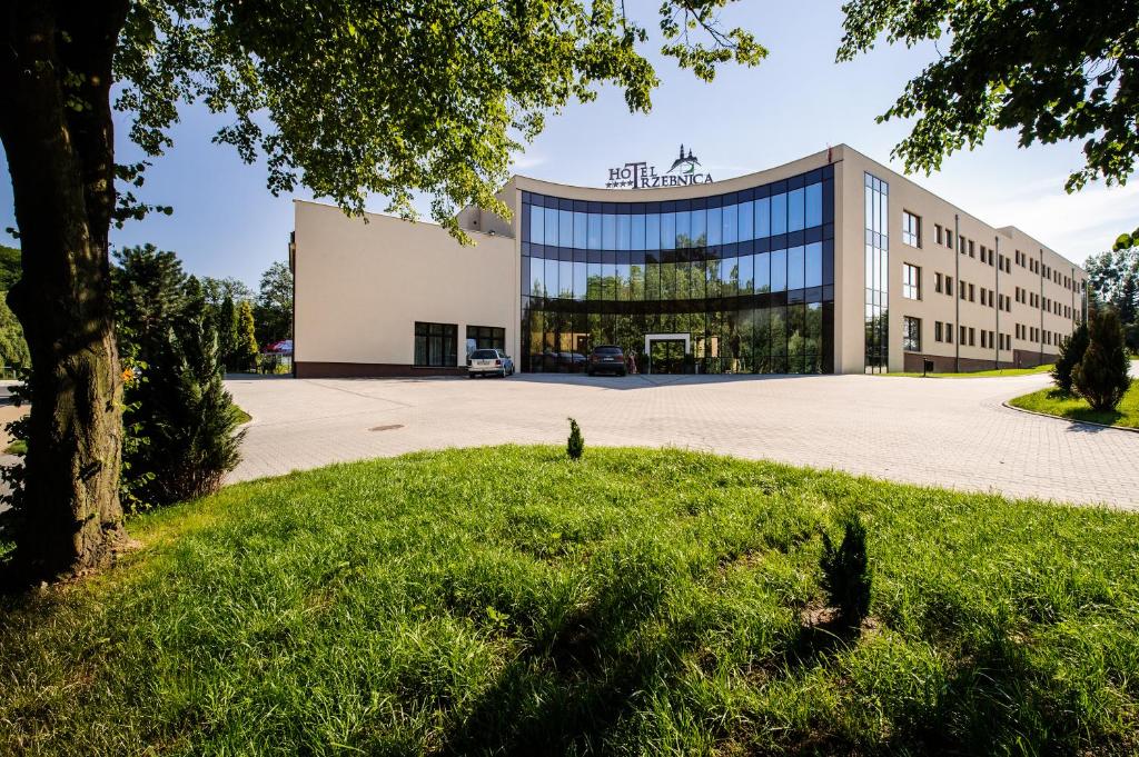 an office building with a large glass facade at Hotel Trzebnica in Trzebnica