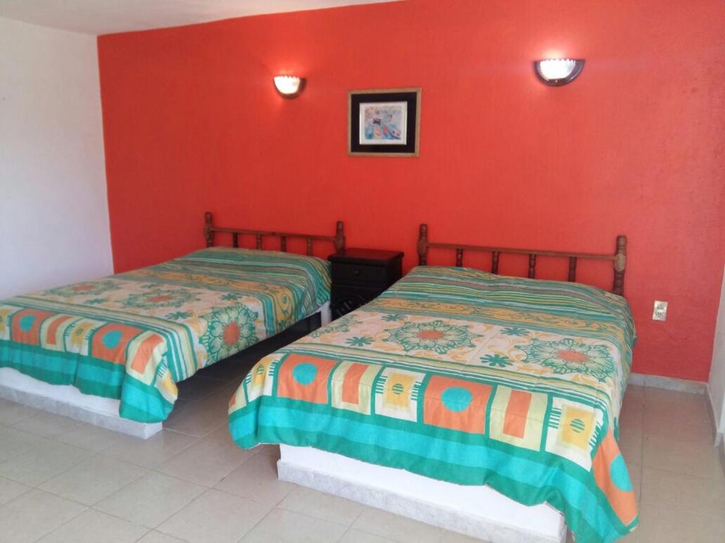 Postel nebo postele na pokoji v ubytování Hotel Playa Krystal
